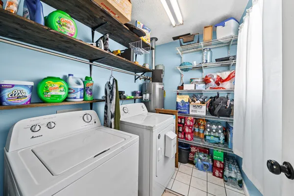 a utility room with lots of clutter and storage