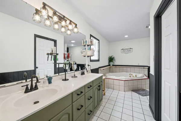 a bathroom with a sink double vanity and a mirror