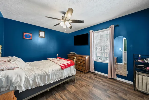a bedroom with a bed and a chandelier