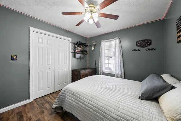 a bedroom with a large bed and a chandelier