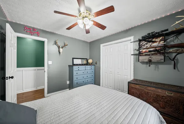 a bedroom with a bed and a chandelier