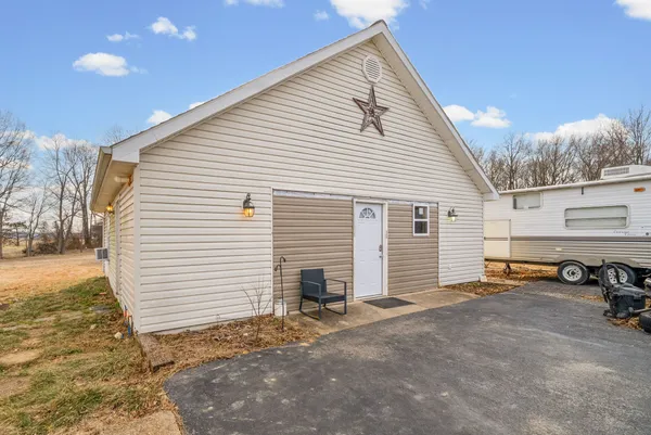 a view of a house with a yard and garage