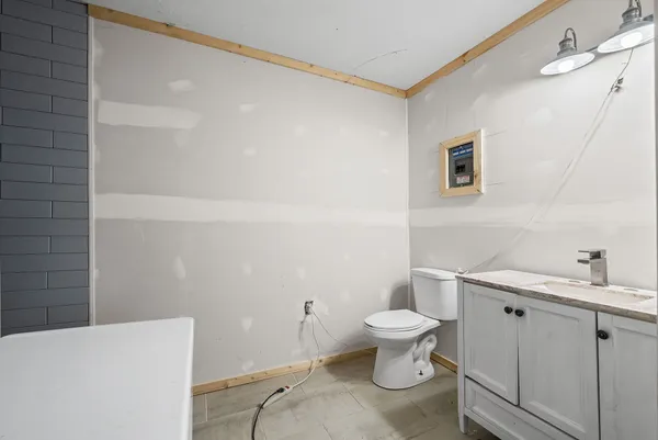 a white toilet sitting next to a bathroom sink
