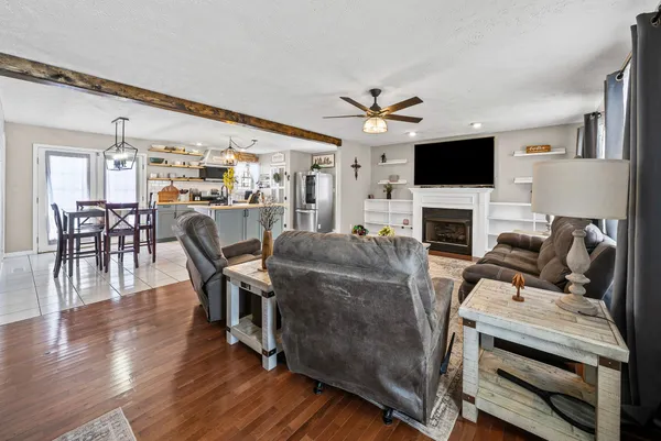 a living room with furniture a flat screen tv and a fireplace
