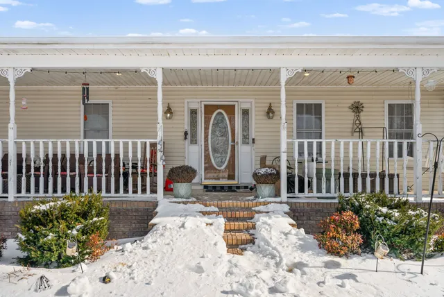 a living room with furniture a ceiling fan and a window