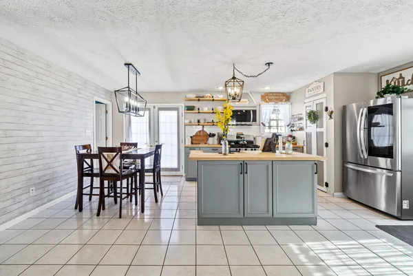 a kitchen with stainless steel appliances granite countertop a sink and a refrigerator