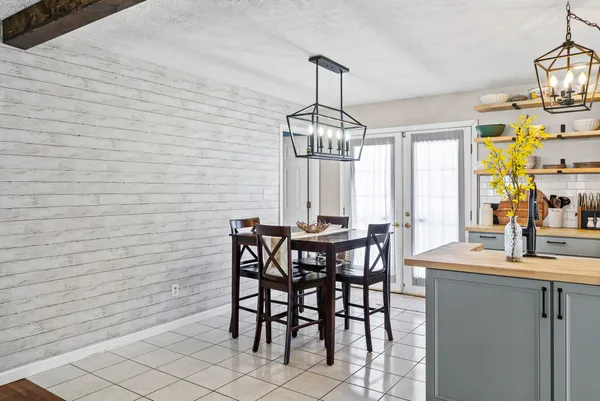 a view of a dining room with furniture and chandelier