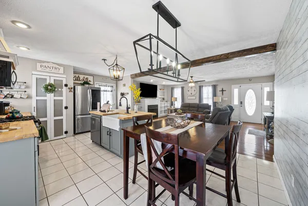 a view of a dining room with furniture and a chandelier