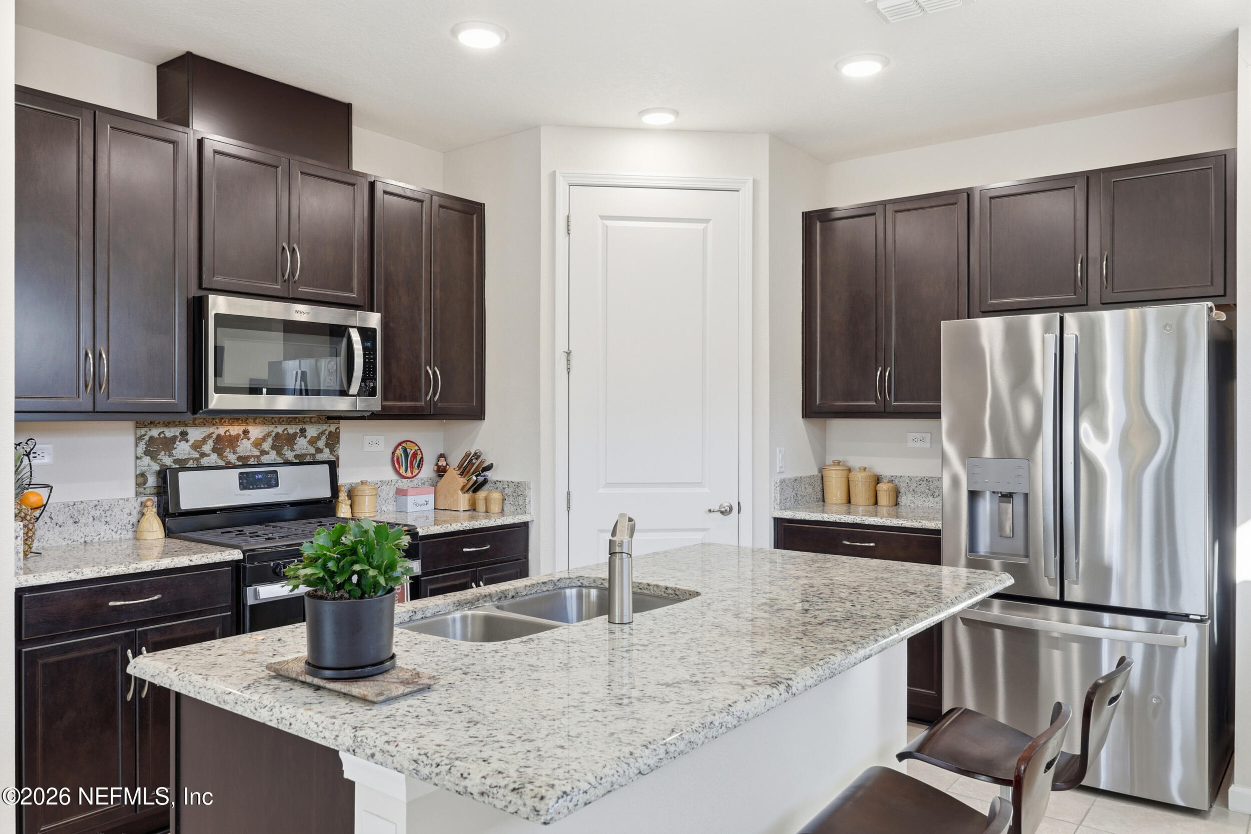 996 Rustic Mill Drive St. Augustine, FL 32092 - Photo 11 of 53 a kitchen with stainless steel appliances granite countertop a refrigerator and a sink