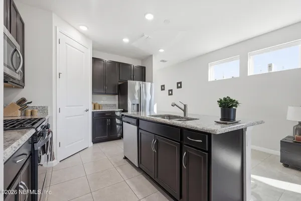 a kitchen with a sink and living room