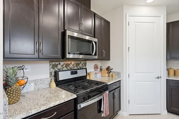 a kitchen with center island table and chairs in it