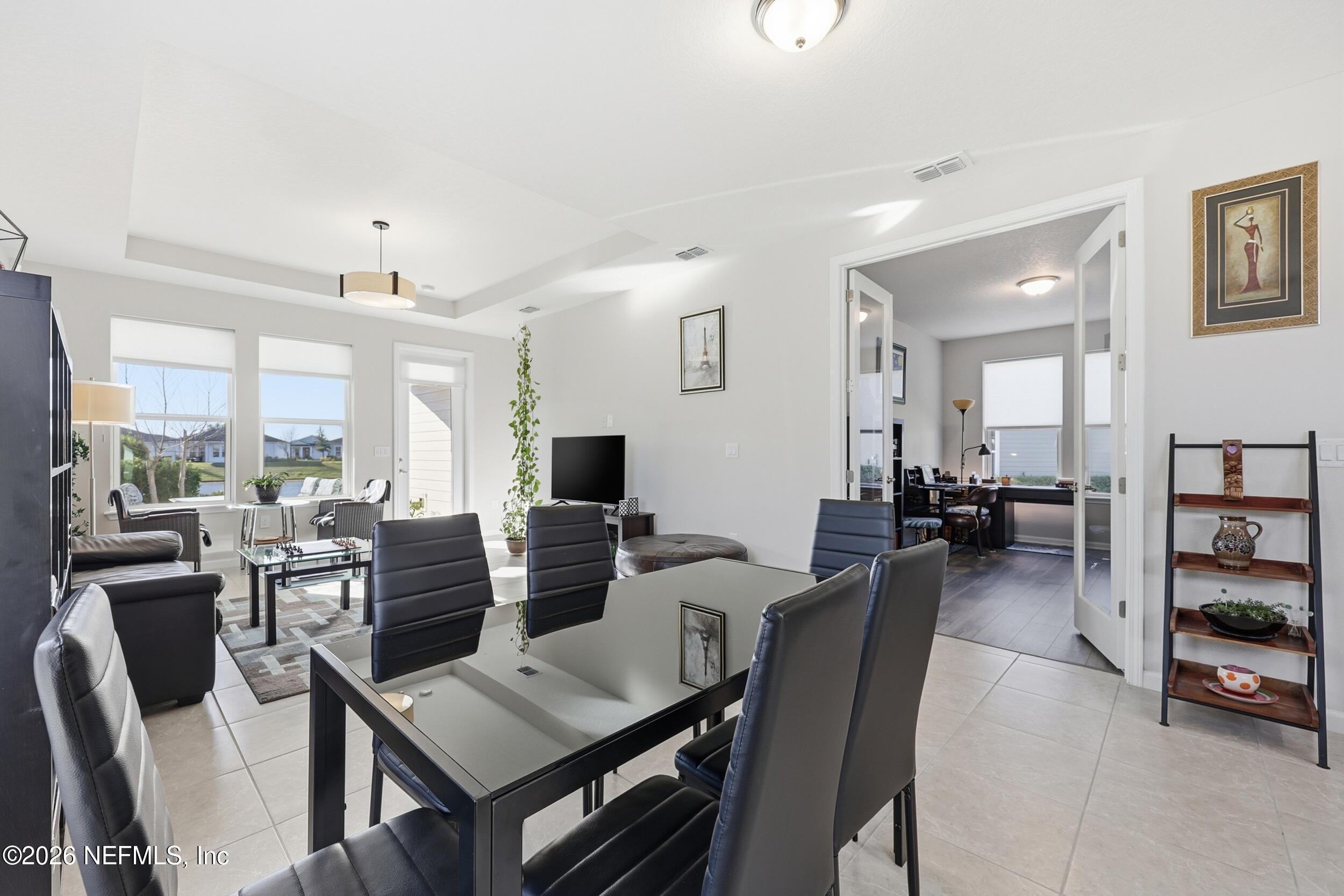 996 Rustic Mill Drive St. Augustine, FL 32092 - Photo 13 of 53 a living room with lots of furniture and a flat screen tv