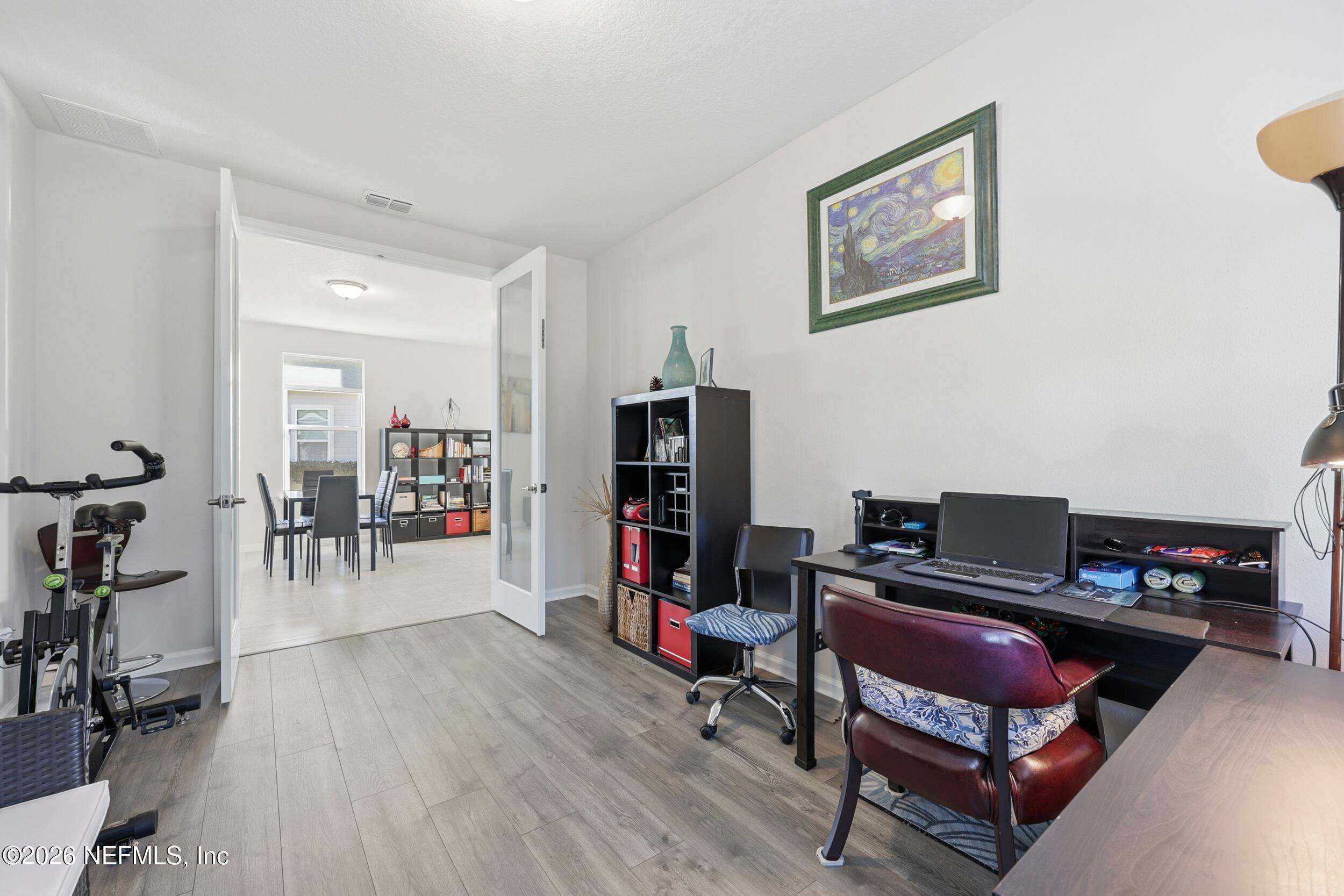996 Rustic Mill Drive St. Augustine, FL 32092 - Photo 15 of 53 a living room with furniture a piano and a bookshelf