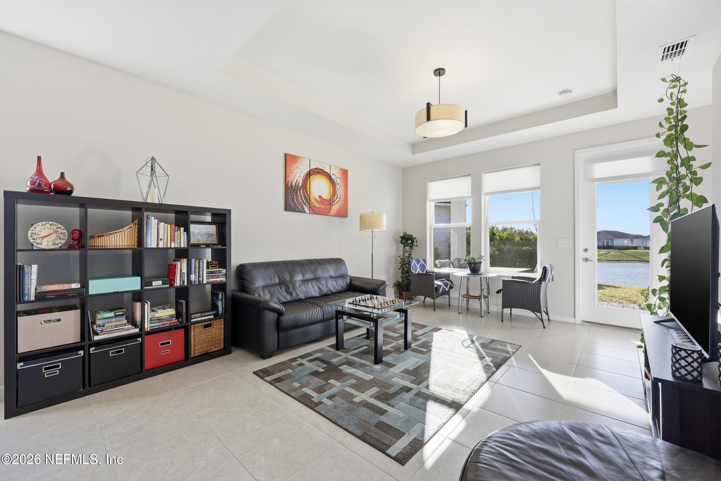 996 Rustic Mill Drive St. Augustine, FL 32092 - Photo 16 of 53 a living room with furniture and a flat screen tv