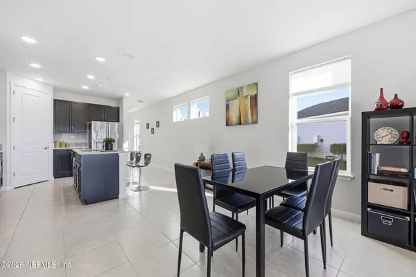 a living room with furniture and kitchen view