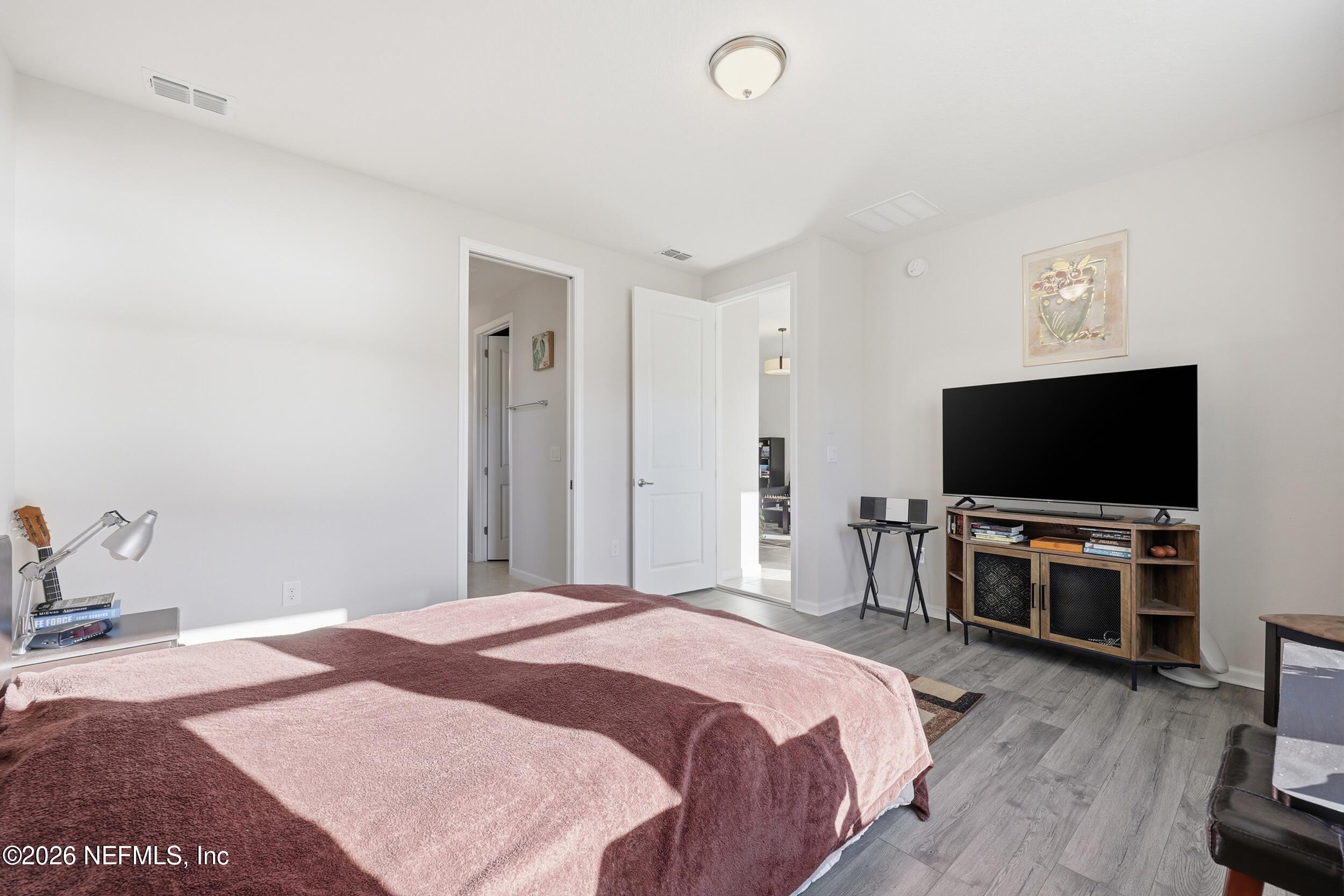 996 Rustic Mill Drive St. Augustine, FL 32092 - Photo 21 of 53 a bedroom with a bed and a flat screen tv