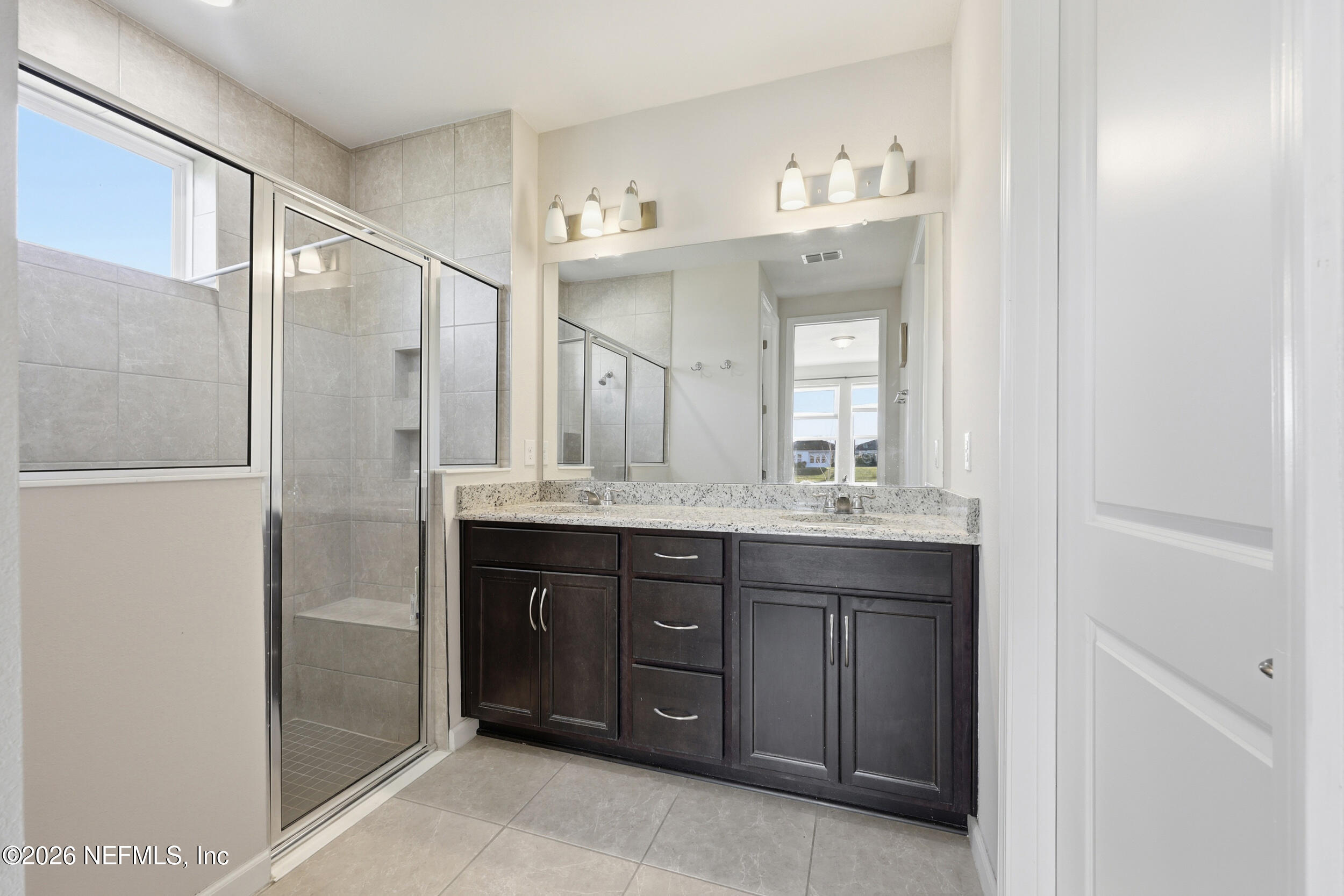 996 Rustic Mill Drive St. Augustine, FL 32092 - Photo 22 of 53 a bathroom with a double vanity sink mirror and shower