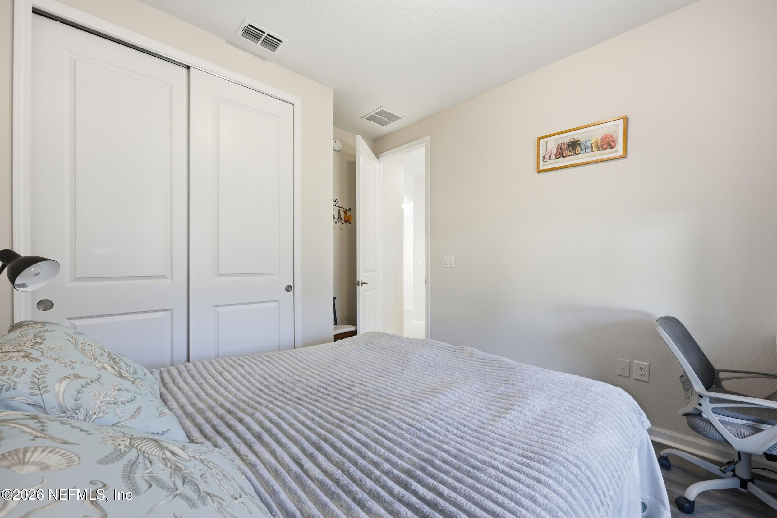 996 Rustic Mill Drive St. Augustine, FL 32092 - Photo 24 of 53 a bedroom with a bed and a cabinets