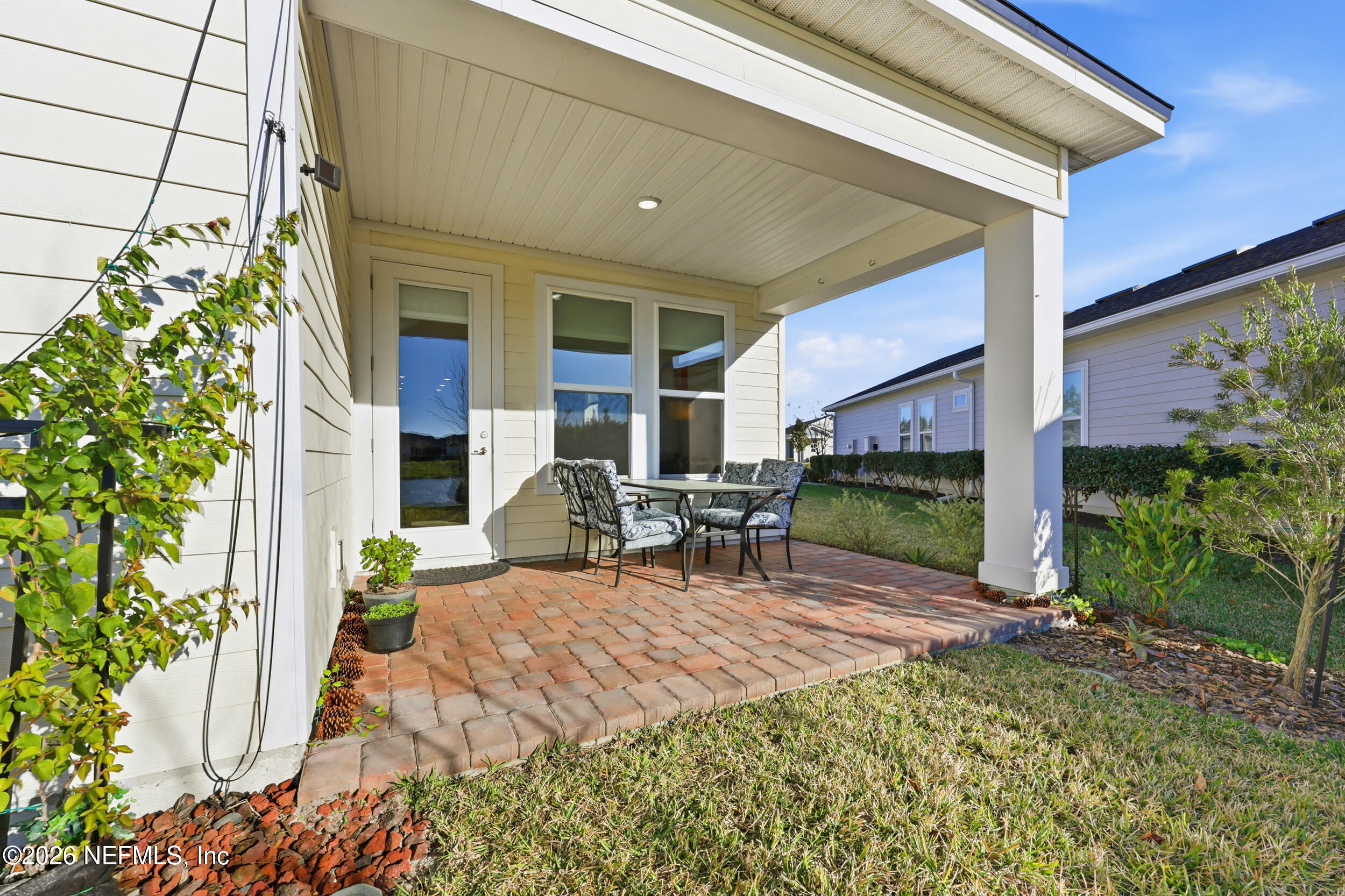 996 Rustic Mill Drive St. Augustine, FL 32092 - Photo 28 of 53 a view of a patio with table and chairs potted plants and floor to ceiling window
