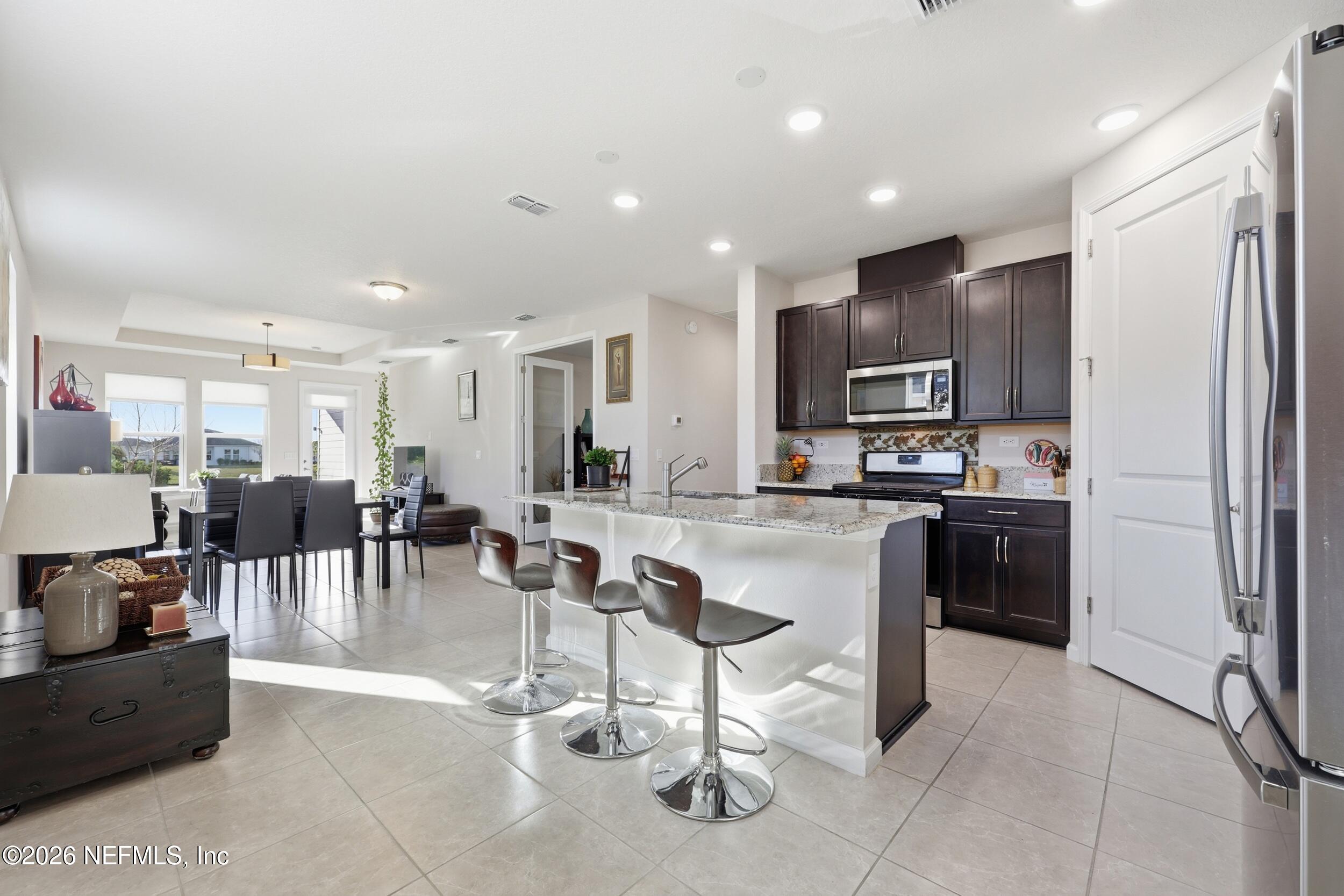 996 Rustic Mill Drive St. Augustine, FL 32092 - Photo 5 of 53 a kitchen with kitchen island granite countertop lots of counter top space and stainless steel appliances