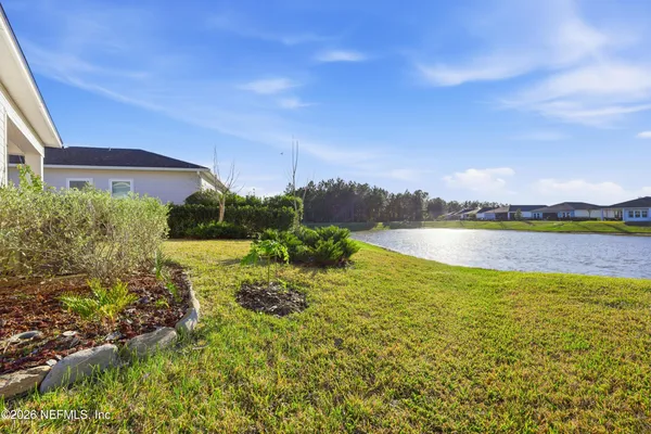 a view of a lake with houses in the back
