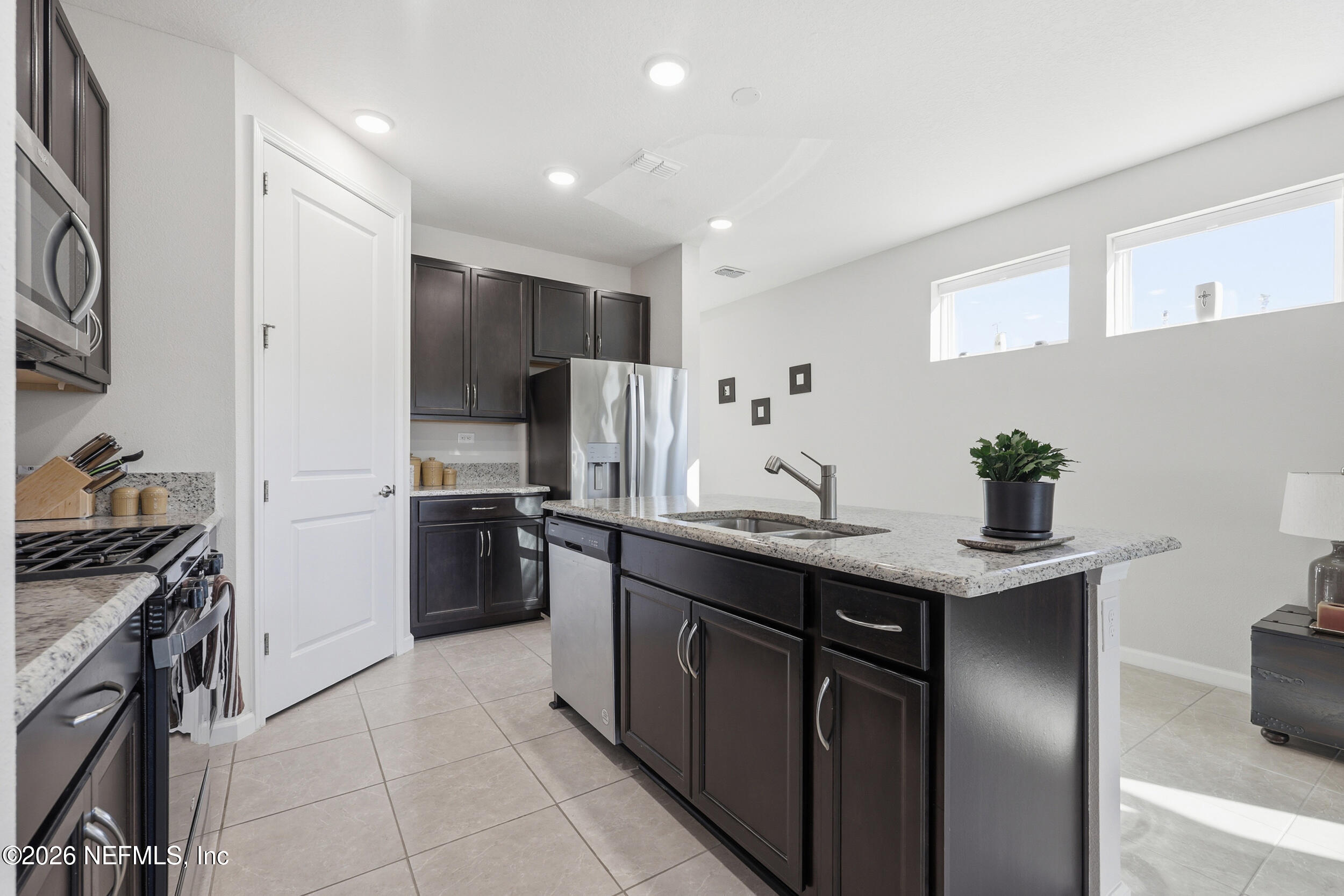 996 Rustic Mill Drive St. Augustine, FL 32092 - Photo 7 of 53 a kitchen with stainless steel appliances granite countertop a sink stove and refrigerator