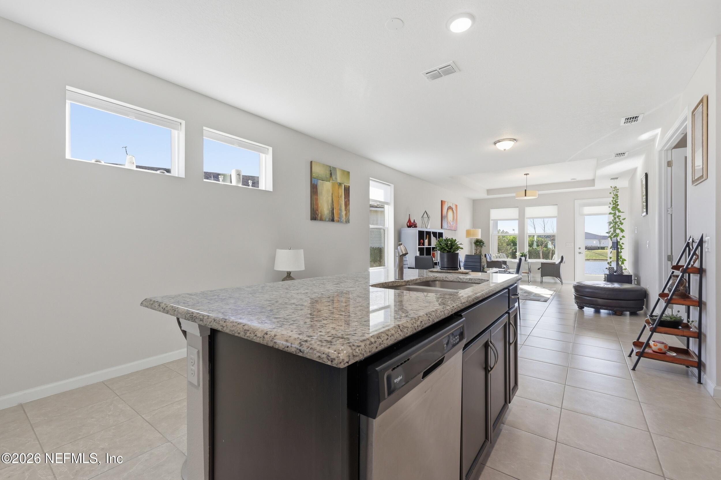 996 Rustic Mill Drive St. Augustine, FL 32092 - Photo 10 of 53 a kitchen with center island table and chairs in it