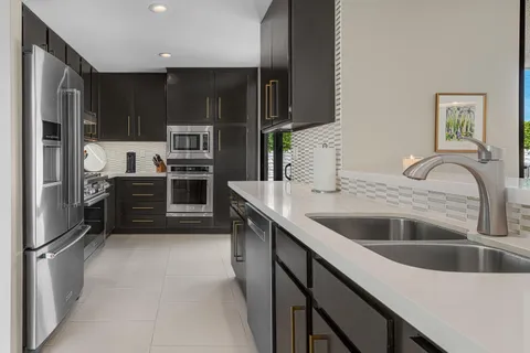 a kitchen with stainless steel appliances wooden cabinets and a sink