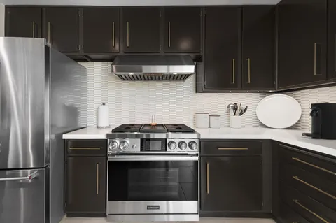 a kitchen with a stove a microwave and a sink