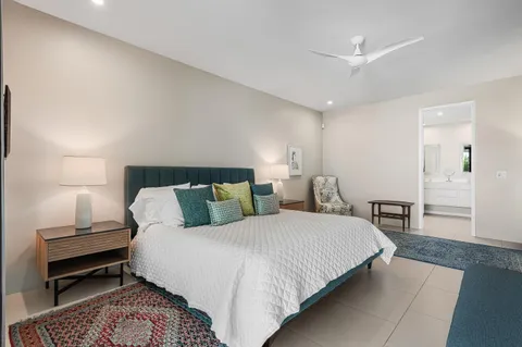 a spacious bathroom with a tub sink and mirror