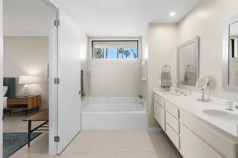 a bedroom with a bed and large window