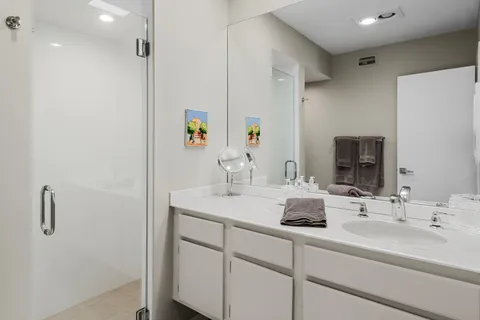 a view of a house with pool and chairs