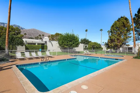 a view of a swimming pool with a yard