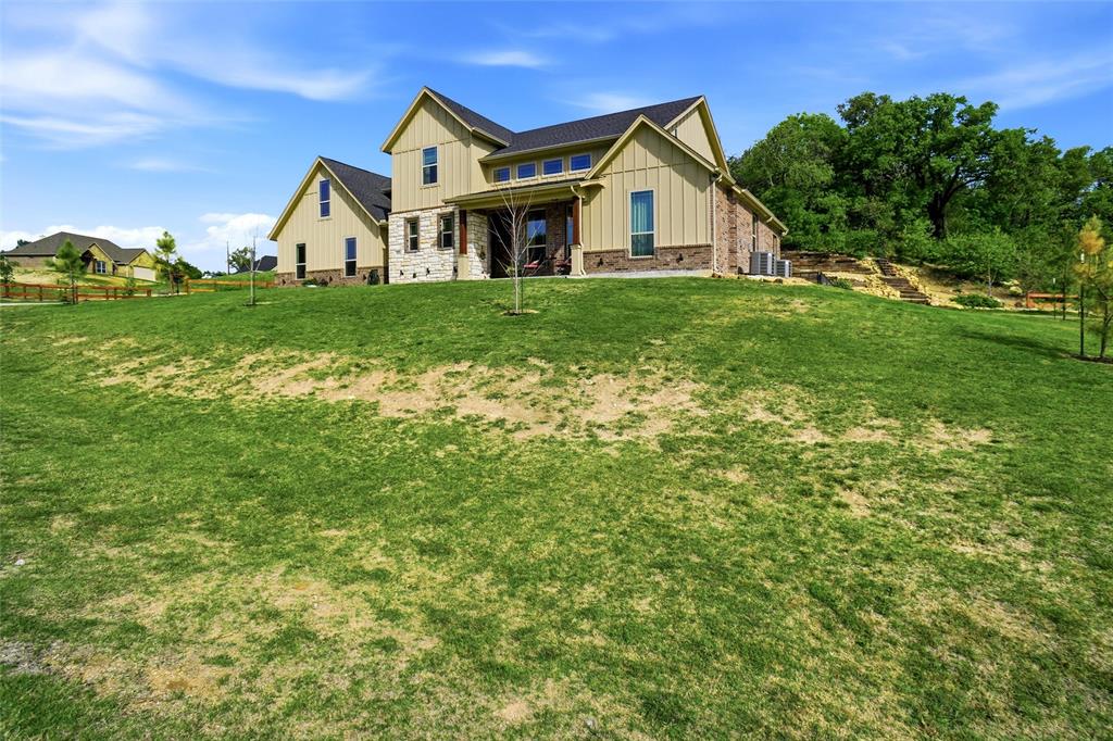 1024 Tex Lane Springtown, TX 76082 - Photo 39 of 40 a view of a house with a big yard and large trees