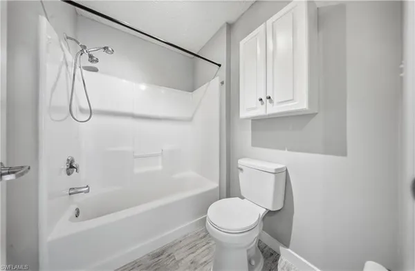 a bathroom with a toilet and a bathtub
