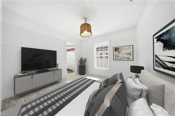 a bedroom with furniture and a flat screen tv