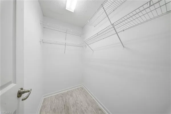 a view of a room with wooden floor and window