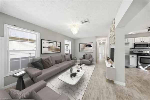 an empty room with windows and cabinet