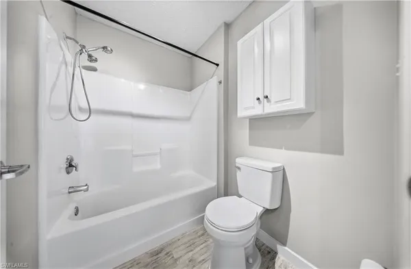 a bathroom with a toilet and a bathtub