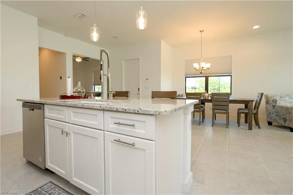 a kitchen with center island table and chairs