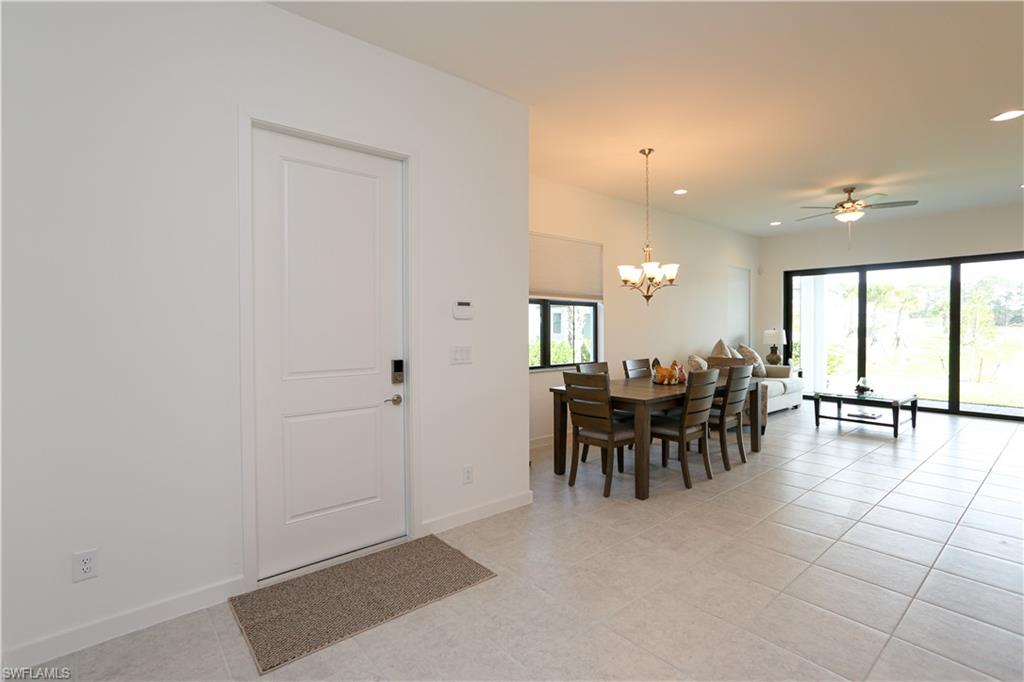 14759 Kingfisher Loop Naples, FL 34120 - Photo 15 of 35 an dining room with furniture and outdoor view