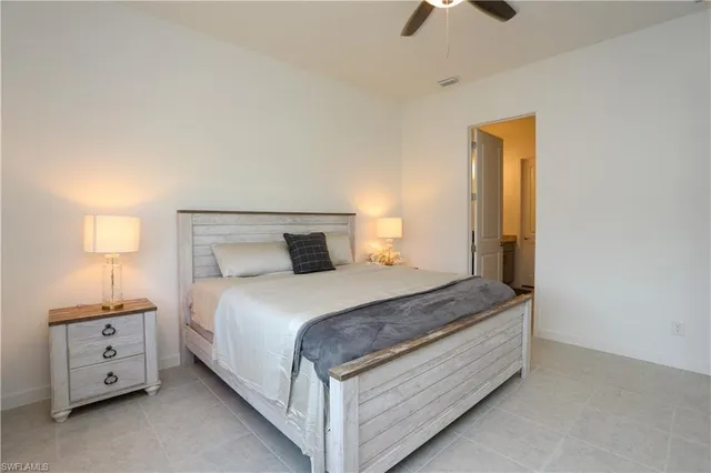 a bedroom with a bed and a ceiling fan