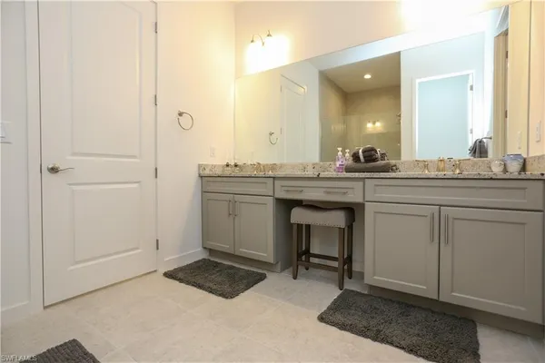 a spacious bathroom with a sink a mirror and a
