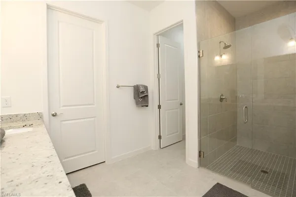 a bathroom with a shower and a sink
