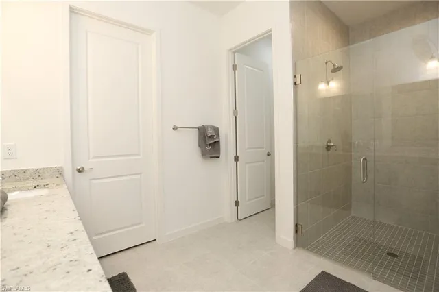 a bathroom with a shower and a sink