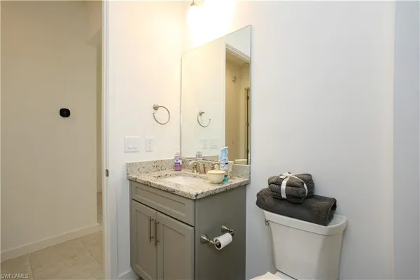 a bathroom with a sink toilet and vanity