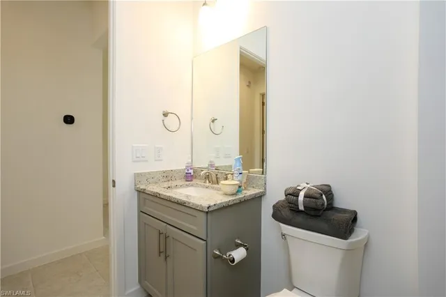 a bathroom with a sink toilet and vanity