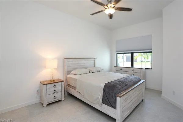 a bedroom with a bed and window