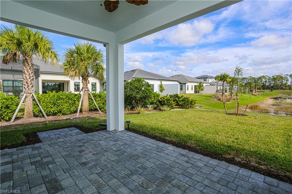14759 Kingfisher Loop Naples, FL 34120 - Photo 32 of 35 a view of a house with a garden