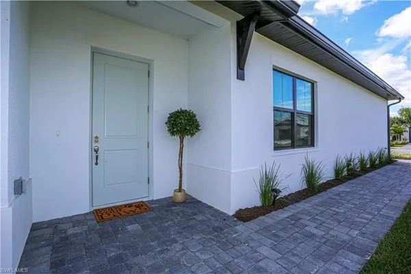 a view of an entryway of house with potted plants